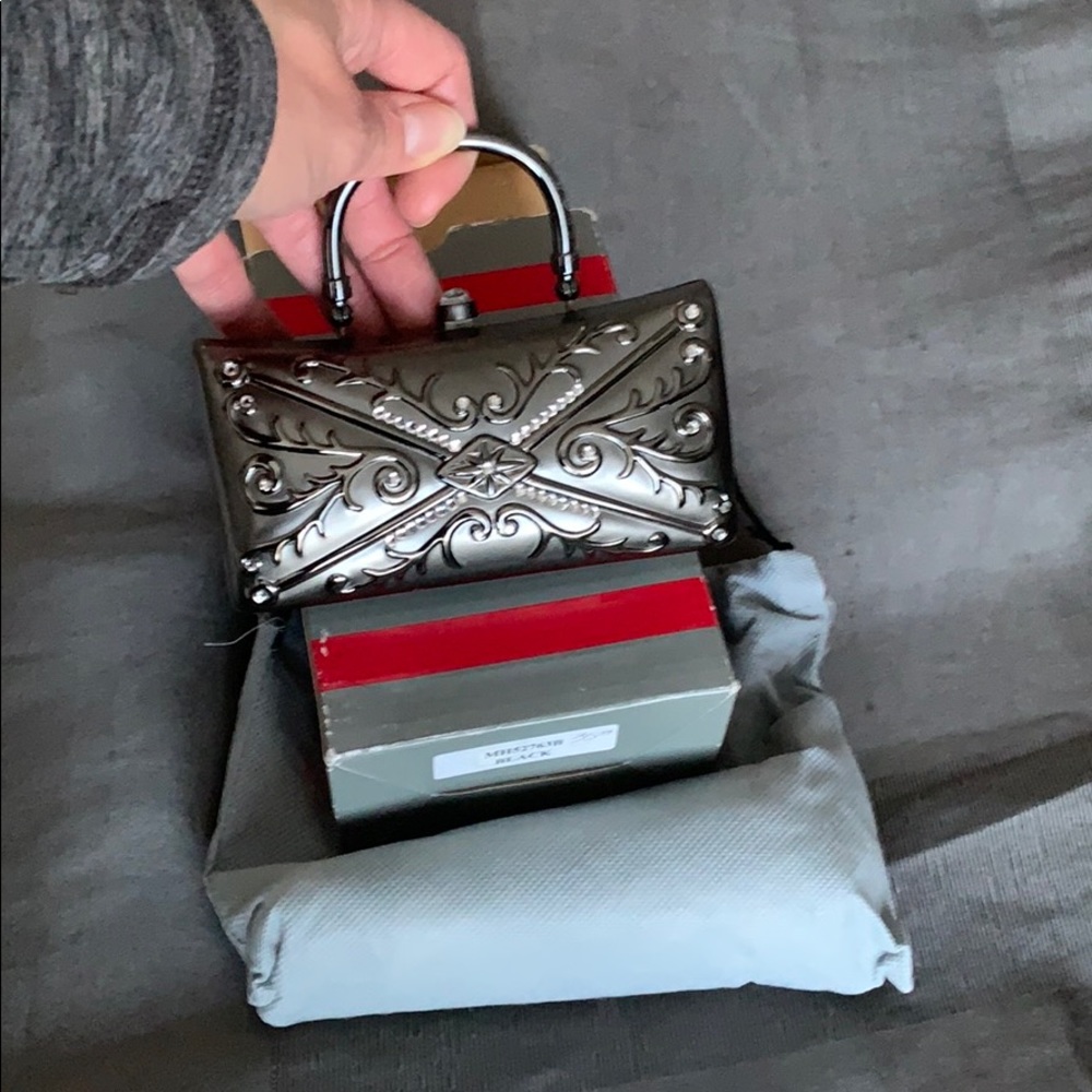 Tiny hard sided clutch bag